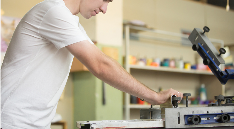 Worker preparing a silk-screen printing frame